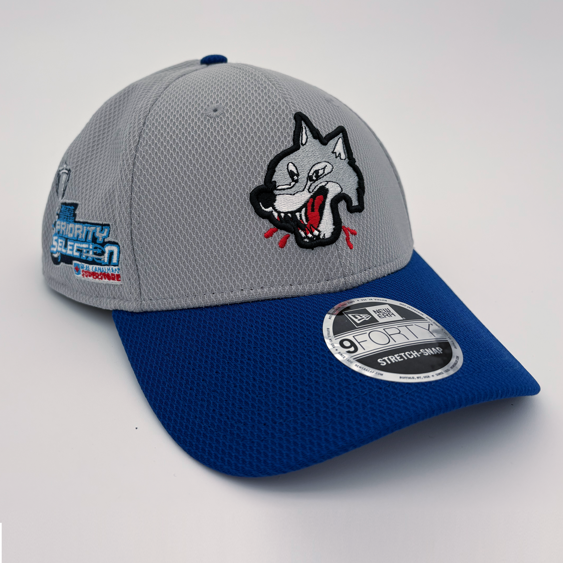 A grey and blue baseball cap with the Sudbury Wolves Logo on the front, and OHL Priority Selection logo on the right side.